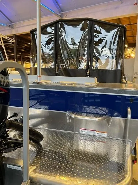 Slide: The Image of 2024 Spartan 185 Astoria boat interior with diamond plate flooring and protective canopy. - 9