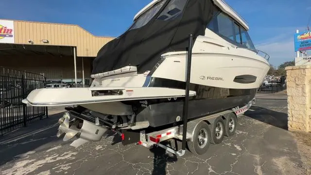 Slide: The Image of 2023 Regal 36 Grande Coupe boat on trailer in parking lot. - 1