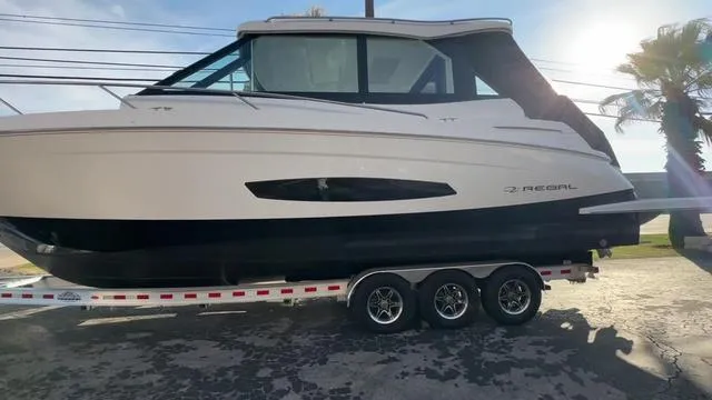Slide: The Image of 2023 Regal 36 Grande Coupe boat on trailer, side view, sunny day. - 10
