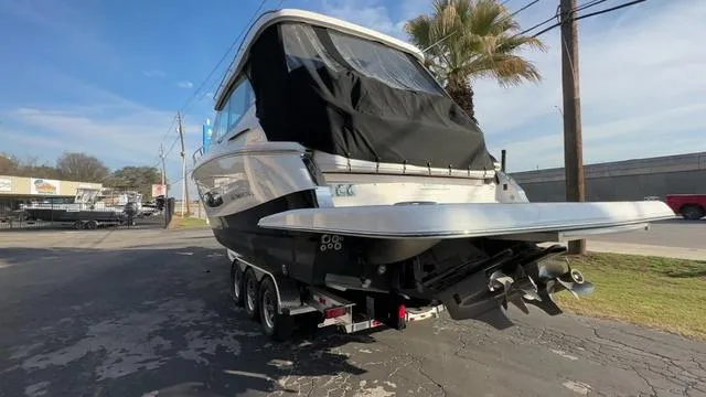 Slide: The Image of 2023 Regal 36 Grande Coupe boat on trailer, rear view, outdoor setting. - 12