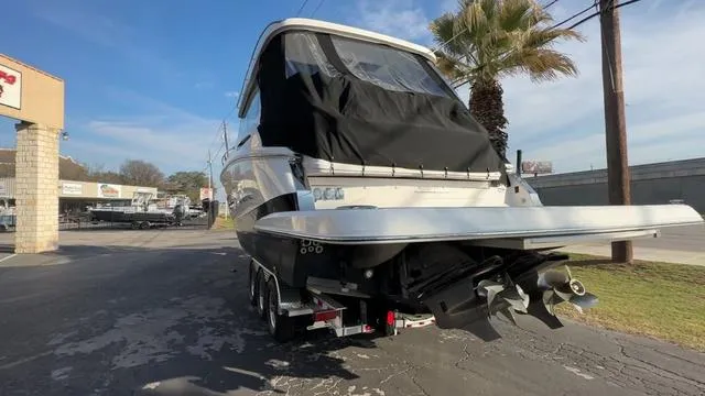 Slide: The Image of 2023 Regal 36 Grande Coupe boat on trailer, rear view, sunny day. - 13