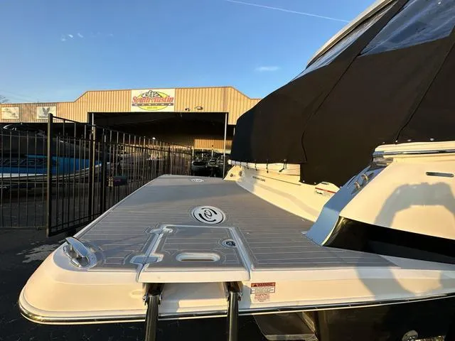 Slide: The Image of 2023 Regal 36 Grande Coupe yacht with swim platform, docked near a marina. - 14