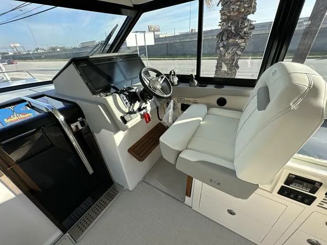 Slide: The Image of 2023 Regal 36 Grande Coupe helm with modern controls and plush seating. - 16