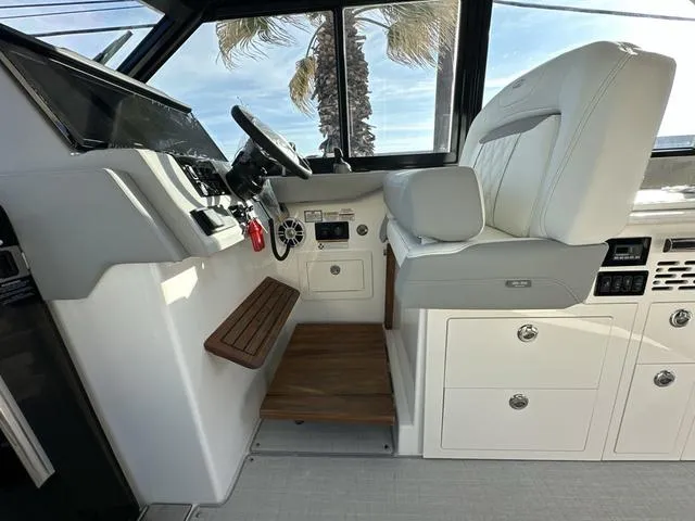 Slide: The Image of 2023 Regal 36 Grande Coupe helm with modern controls and luxurious seating. - 17