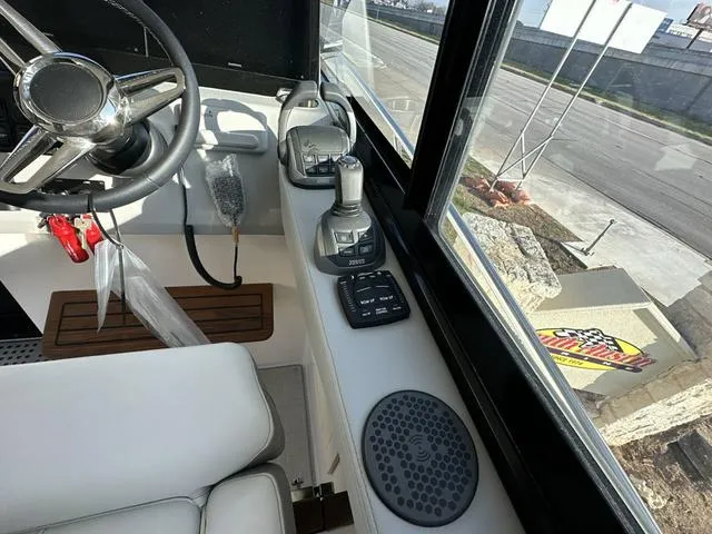 Slide: The Image of Interior cockpit of 2023 Regal 36 Grande Coupe with steering wheel and controls. - 19