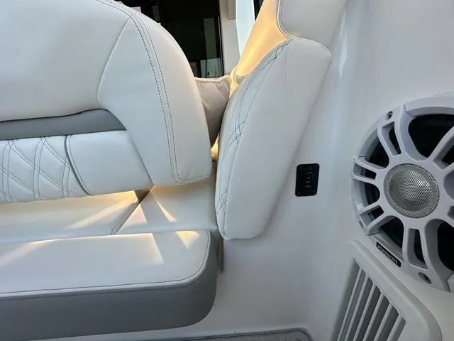 Slide: The Image of 2023 Regal 36 Grande Coupe interior with white leather seating and speaker detail. - 21