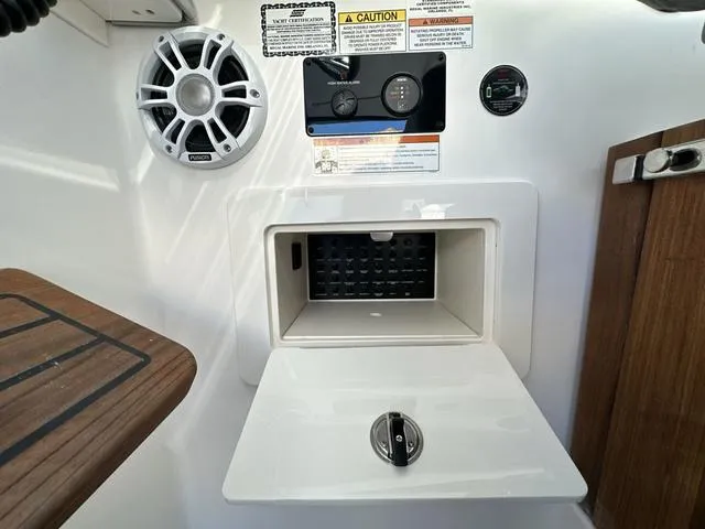 Slide: The Image of 2023 Regal 36 Grande Coupe control panel with speaker and storage compartment. - 26