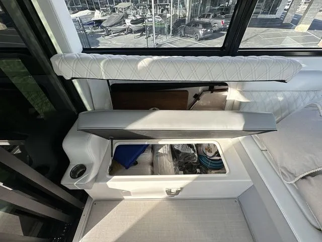Slide: The Image of 2023 Regal 36 Grande Coupe interior storage compartment with open seat cushion. - 27