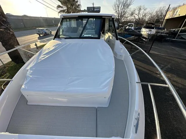 Slide: The Image of 2023 Regal 36 Grande Coupe boat exterior, docked, with covered seating area. - 28