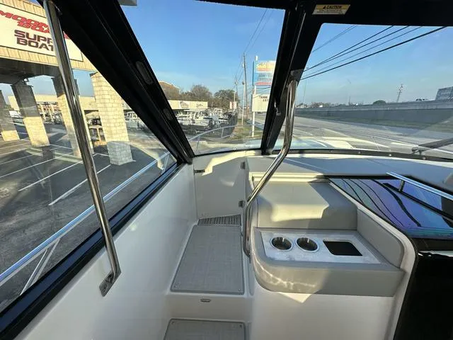 Slide: The Image of Interior view of 2023 Regal 36 Grande Coupe boat cockpit with cup holders. - 29