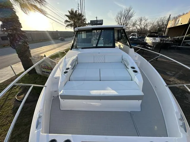 Slide: The Image of 2023 Regal 36 Grande Coupe boat with spacious deck and seating area. - 30