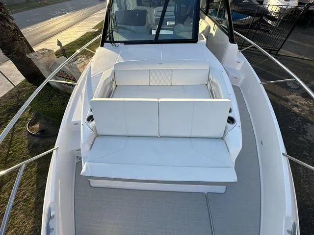 Slide: The Image of 2023 Regal 36 Grande Coupe boat with spacious white seating area. - 31