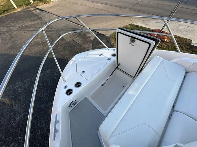 Slide: The Image of 2023 Regal 36 Grande Coupe boat deck with open storage compartment and seating. - 35