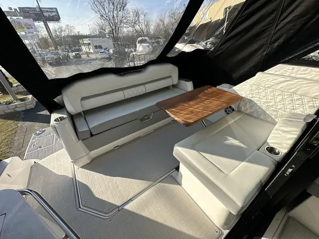 Slide: The Image of Luxurious interior of 2023 Regal 36 Grande Coupe with elegant seating and wooden table. - 36