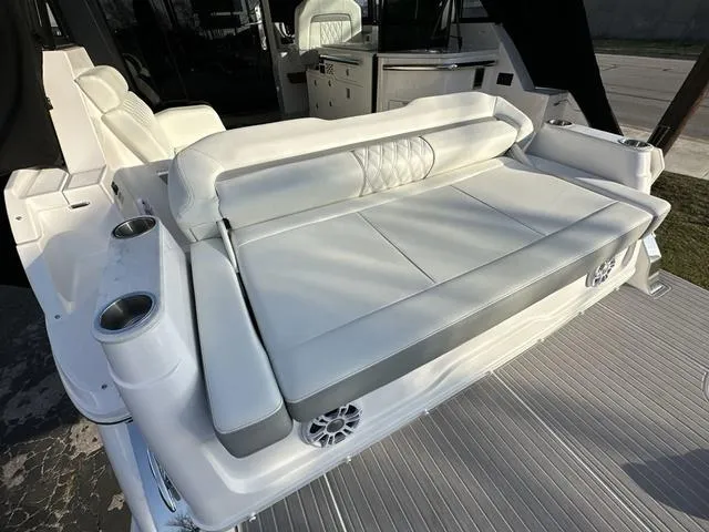 Slide: The Image of 2023 Regal 36 Grande Coupe luxury boat interior with white seating and cup holders. - 40
