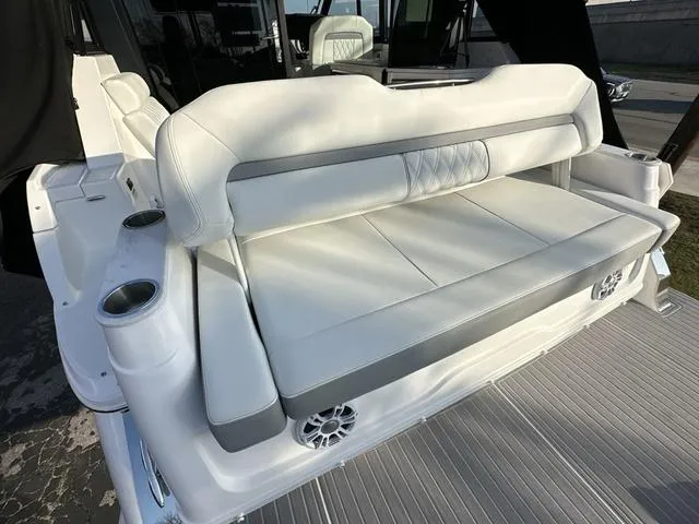 Slide: The Image of 2023 Regal 36 Grande Coupe luxury boat seating with cup holders and speakers. - 41