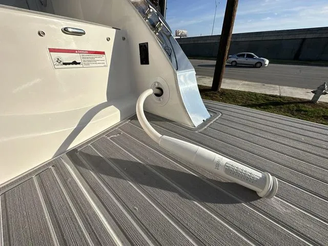 Slide: The Image of 2023 Regal 36 Grande Coupe boat deck with water hose attachment. - 42