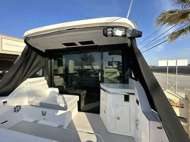 Slide: The Image of 2023 Regal 36 Grande Coupe boat with spacious seating and modern design. - 46