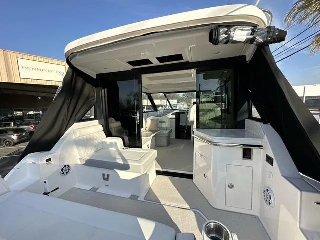 Slide: The Image of 2023 Regal 36 Grande Coupe luxury yacht interior with seating and modern amenities. - 48