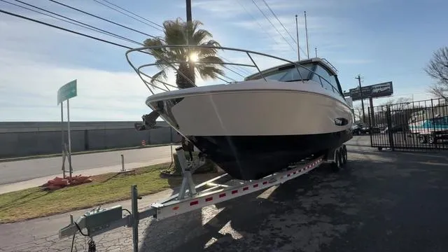 Slide: The Image of 2023 Regal 36 Grande Coupe boat on trailer, parked outdoors. - 7