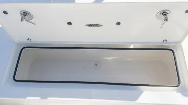 Slide: The Image of 2024 Hewes 16 Redfisher boat storage compartment with secure latches. - 13