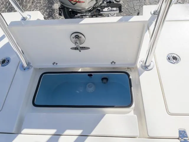 Slide: The Image of 2024 Hewes 16 Redfisher boat livewell and storage compartment. - 14