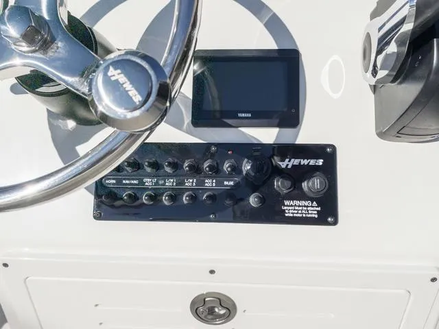 Slide: The Image of Control panel of 2024 Hewes 16 Redfisher boat with steering wheel and Yamaha display. - 18