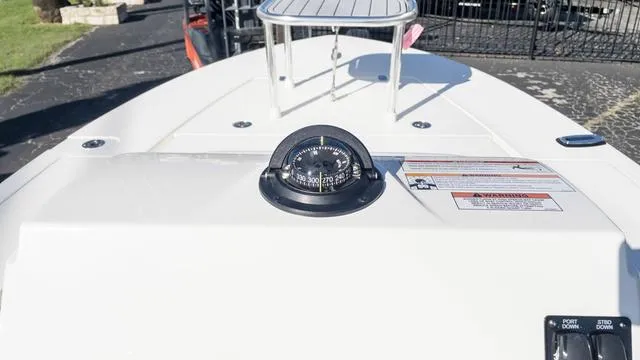 Slide: The Image of 2024 Hewes 16 Redfisher boat dashboard with compass and control panel. - 22