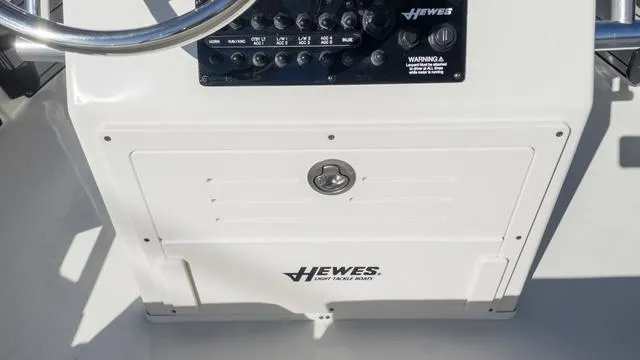 Slide: The Image of 2024 Hewes 16 Redfisher boat console with steering wheel and control panel. - 24