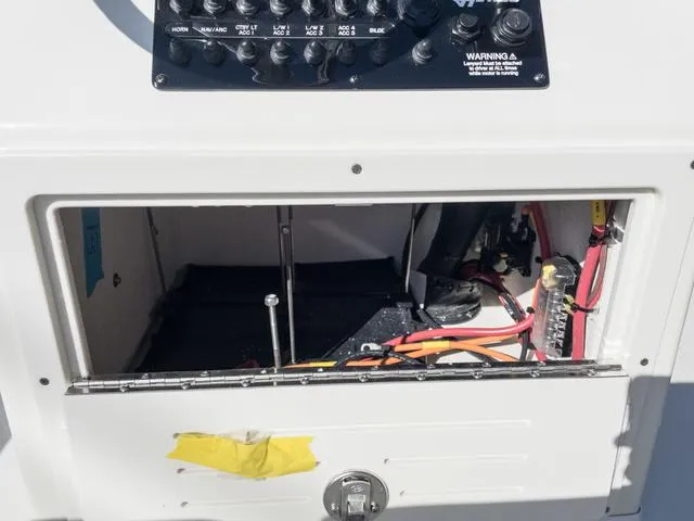 Slide: The Image of Open electrical panel on a 2024 Hewes 16 Redfisher boat. - 25