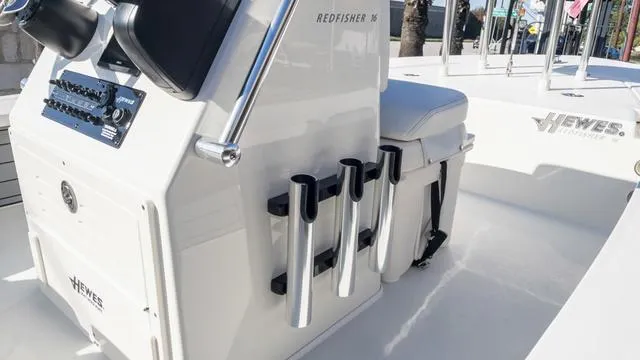 Slide: The Image of 2024 Hewes 16 Redfisher boat interior with rod holders and console. - 27