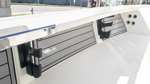 Slide: The Image of 2024 Hewes 16 Redfisher boat interior with rod holders and storage compartments. - 28