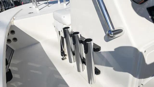 Slide: The Image of 2024 Hewes 16 Redfisher boat interior with rod holders and console. - 29