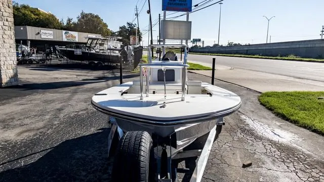 Slide: The Image of 2024 Hewes 16 Redfisher boat on trailer in outdoor dealership lot. - 3