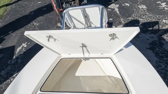 Slide: The Image of 2024 Hewes 16 Redfisher boat with open storage compartment. - 32