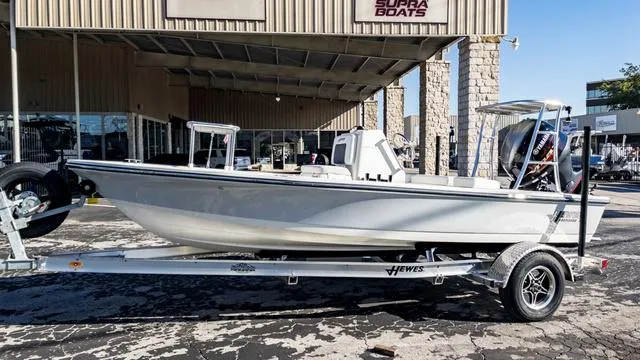 Slide: The Image of 2024 Hewes 16 Redfisher boat on trailer outside Supra Boats dealership. - 5