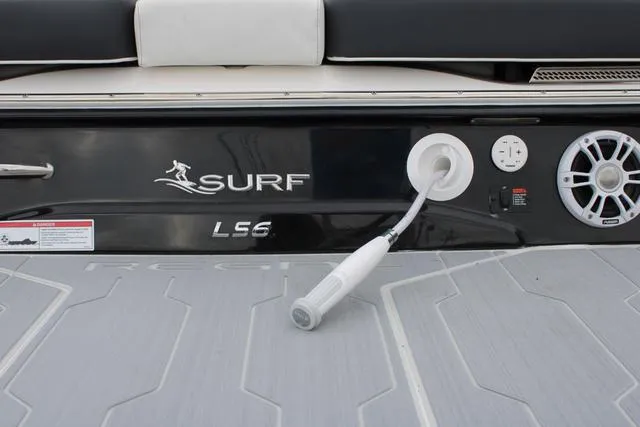 Slide: The Image of 2024 Regal LS6 Surf boat deck with speaker and hose attachment. - 11