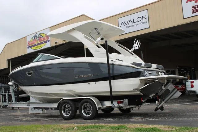 Slide: The Image of 2024 Regal LS6 Surf boat on trailer outside dealership. - 12