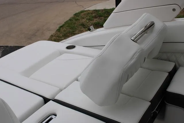 Slide: The Image of 2024 Regal LS6 Surf boat interior with white leather seating and cup holder. - 23
