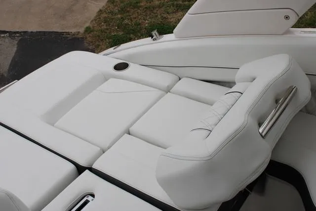 Slide: The Image of 2024 Regal LS6 Surf boat with luxurious white seating and cup holder. - 24