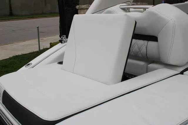 Slide: The Image of 2024 Regal LS6 Surf boat with luxurious white seating and sleek design. - 26