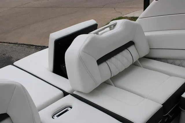 Slide: The Image of 2024 Regal LS6 Surf boat interior with luxurious white seating. - 27