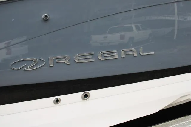 Slide: The Image of 2024 Regal LS6 Surf boat with sleek gray and white exterior. - 3
