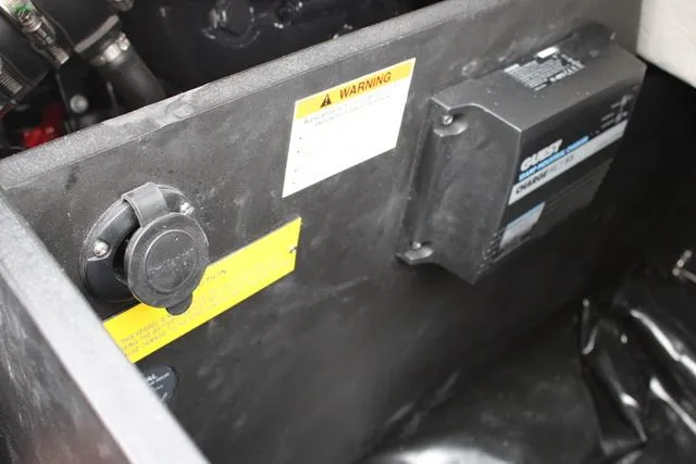 Slide: The Image of 2024 Regal LS6 Surf engine compartment with warning labels and electrical components. - 30