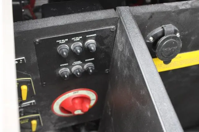Slide: The Image of 2024 Regal LS6 Surf boat control panel with switches and red valve. - 31