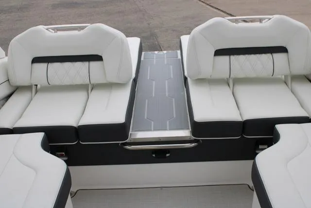 Slide: The Image of 2024 Regal LS6 Surf boat interior with white cushioned seating. - 32