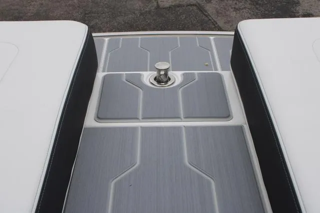 Slide: The Image of 2024 Regal LS6 Surf boat deck with sleek gray and white design. - 33