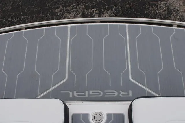 Slide: The Image of 2024 Regal LS6 Surf boat deck with sleek design and branding. - 34