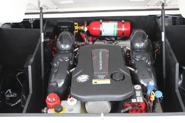 Slide: The Image of 2024 Regal LS6 Surf engine compartment with Volvo Penta engine and fire extinguisher. - 36
