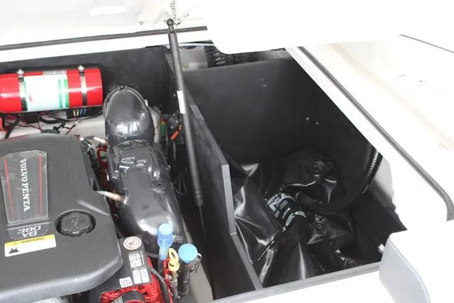 Slide: The Image of 2024 Regal LS6 Surf engine compartment with Volvo Penta engine and fire extinguisher. - 38